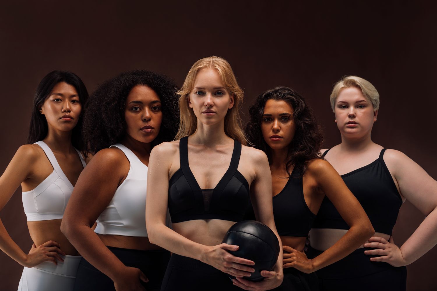 women standing wearing sports bras in different styles and colours